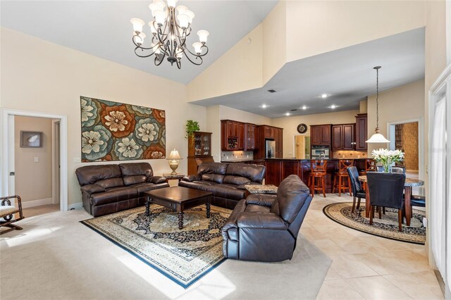 living room featuring light tile patterned flooring, high vaulted ceiling, a notable chandelier, and baseboards