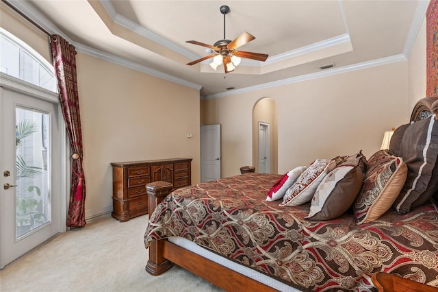 bedroom with carpet flooring, access to exterior, a tray ceiling, visible vents, and ornamental molding