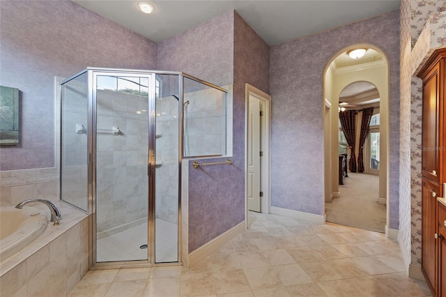 full bath featuring baseboards, a shower stall, tile patterned floors, and a bath