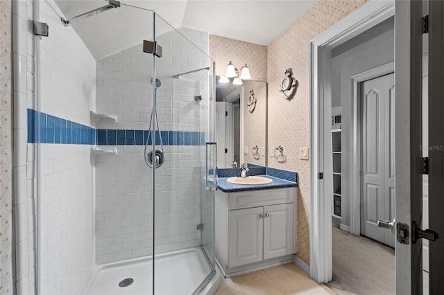 bathroom featuring vanity, tile patterned flooring, a stall shower, and wallpapered walls