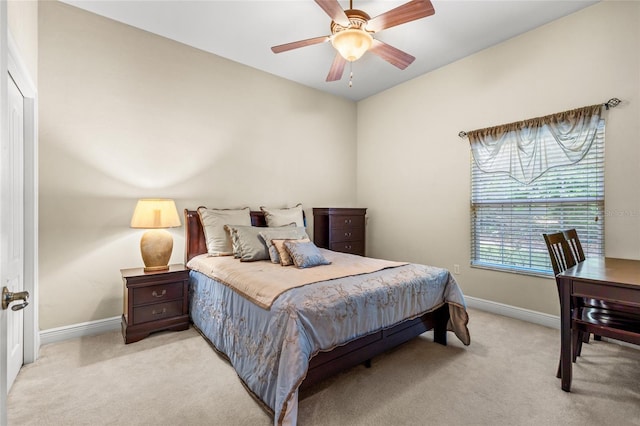 bedroom featuring baseboards, a ceiling fan, and light colored carpet