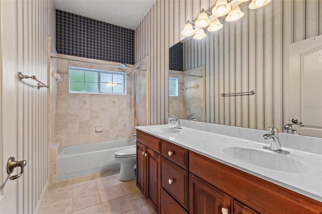 bathroom featuring tile patterned flooring, a sink, toilet, and wallpapered walls