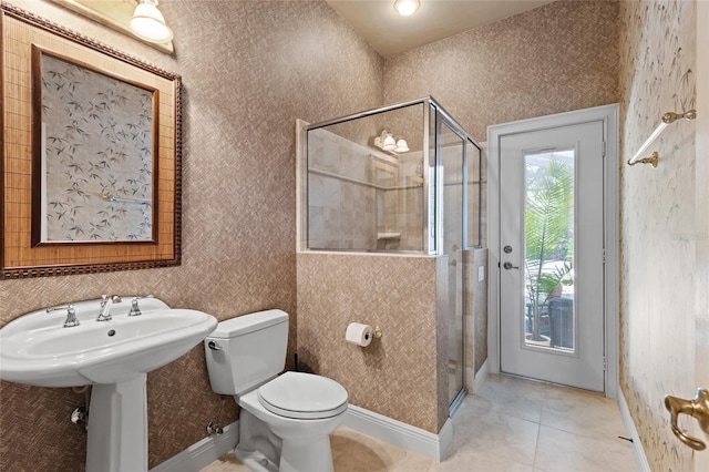 full bath featuring toilet, wallpapered walls, and a shower stall