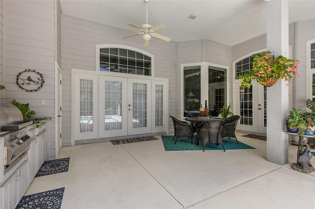 view of patio / terrace featuring french doors, a ceiling fan, outdoor dining space, and area for grilling