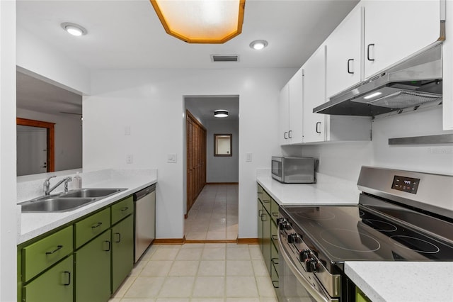 2822 SW 14th Dr Unit 307, Gainesville, FL 32608 - kitchen with appliances with stainless steel finishes, green cabinets, under cabinet range hood, and light countertops