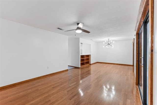 2822 SW 14th Dr Unit 307, Gainesville, FL 32608 - unfurnished room with a chandelier, light wood-style floors, and ceiling fan