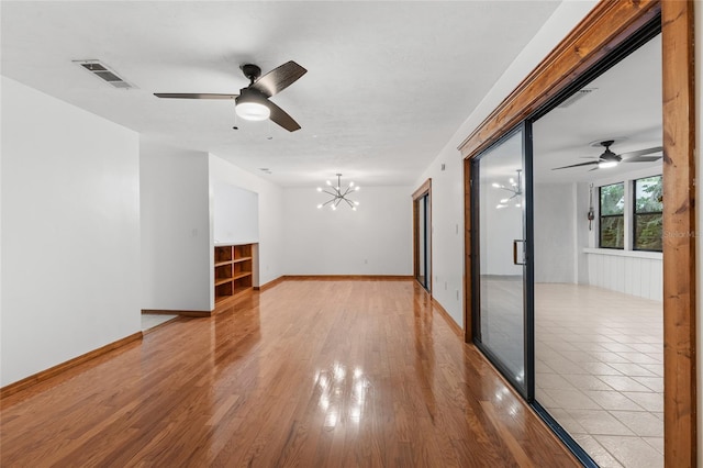 2822 SW 14th Dr Unit 307, Gainesville, FL 32608 - unfurnished room with a chandelier, ceiling fan, and light wood-style flooring