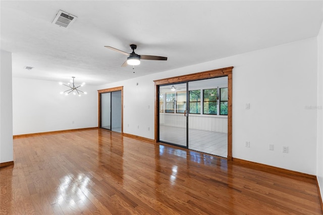 2822 SW 14th Dr Unit 307, Gainesville, FL 32608 - unfurnished room featuring a chandelier, ceiling fan, and wood finished floors