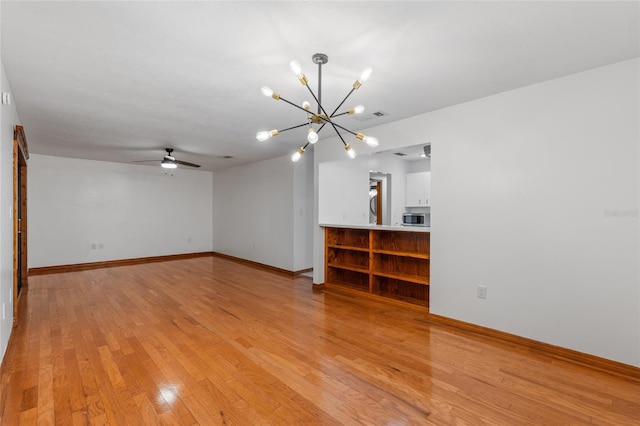 2822 SW 14th Dr Unit 307, Gainesville, FL 32608 - unfurnished living room with a chandelier, light wood-style floors, and a ceiling fan
