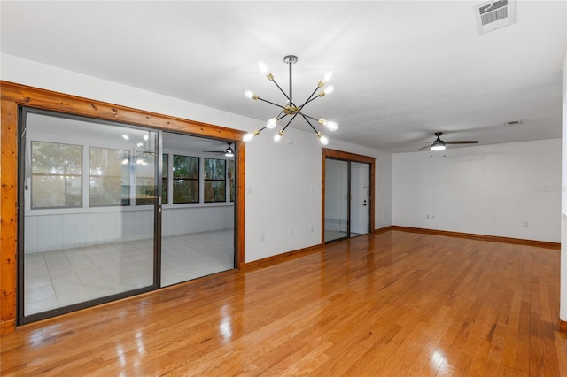 2822 SW 14th Dr Unit 307, Gainesville, FL 32608 - unfurnished room with a chandelier, a ceiling fan, and wood finished floors