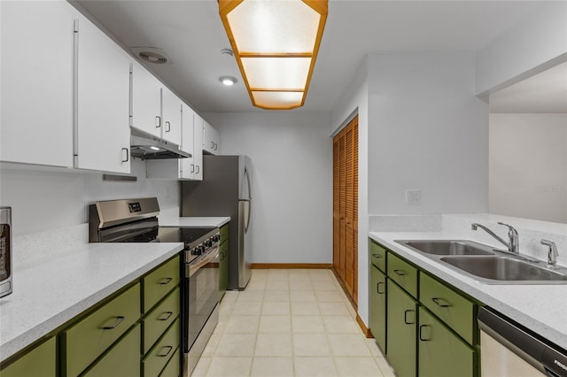 2822 SW 14th Dr Unit 307, Gainesville, FL 32608 - kitchen featuring green cabinets, appliances with stainless steel finishes, under cabinet range hood, light countertops, and white cabinetry