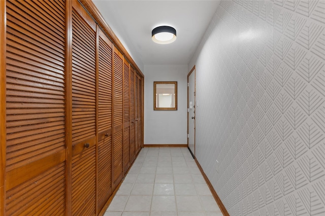 2822 SW 14th Dr Unit 307, Gainesville, FL 32608 - corridor featuring light tile patterned floors and baseboards