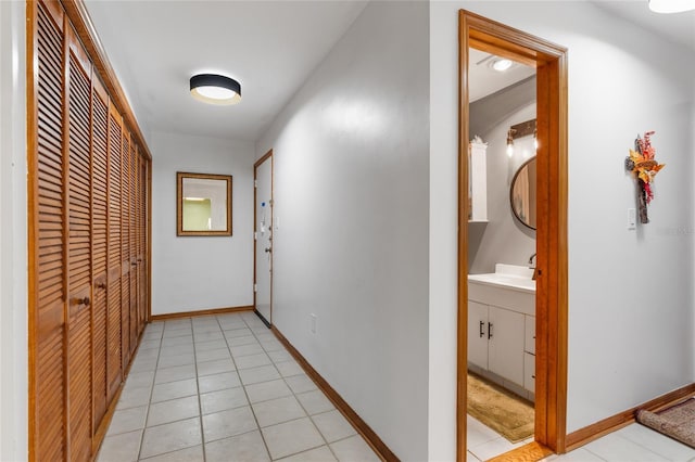 2822 SW 14th Dr Unit 307, Gainesville, FL 32608 - hall featuring light tile patterned flooring and baseboards