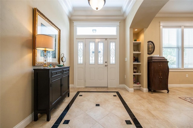 foyer featuring crown molding and baseboards