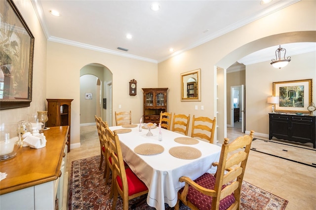 dining space featuring arched walkways, visible vents, crown molding, and recessed lighting