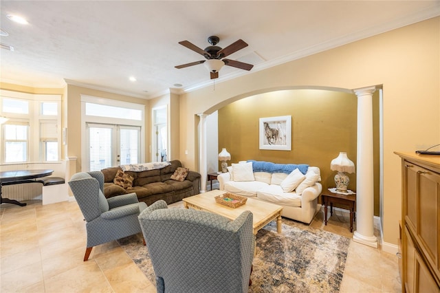 living room featuring ornate columns, ceiling fan, ornamental molding, and arched walkways