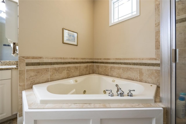 bathroom featuring a whirlpool tub and vanity