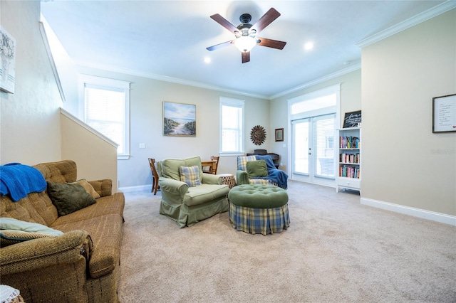 living room featuring ornamental molding, ceiling fan, carpet, and baseboards