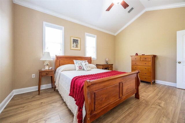 bedroom with light wood-style floors, visible vents, ornamental molding, and vaulted ceiling
