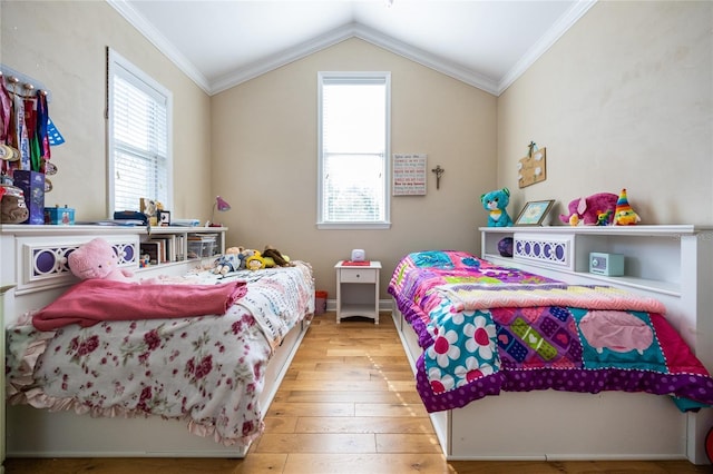 bedroom with hardwood / wood-style floors, vaulted ceiling, crown molding, and multiple windows