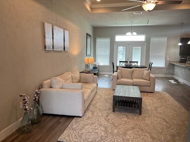 living room with baseboards, ceiling fan, wood finished floors, and visible vents