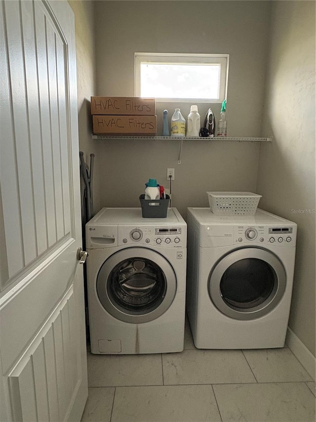 laundry room featuring washer and dryer, laundry area, and light tile patterned floors