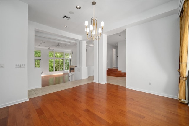 3200 NW 21st Ave, Gainesville, FL 32605 - empty room with hardwood / wood-style flooring, ceiling fan, radiator heating unit, a chandelier, and baseboards