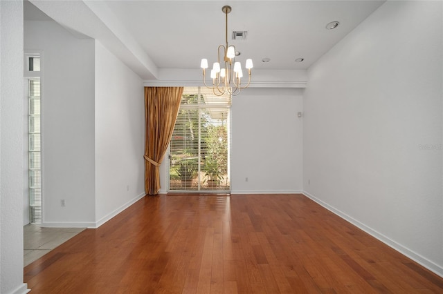 3200 NW 21st Ave, Gainesville, FL 32605 - empty room featuring a chandelier, wood finished floors, and baseboards