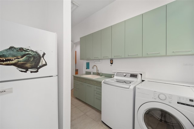 3200 NW 21st Ave, Gainesville, FL 32605 - laundry room with washing machine and clothes dryer, light tile patterned flooring, and cabinet space