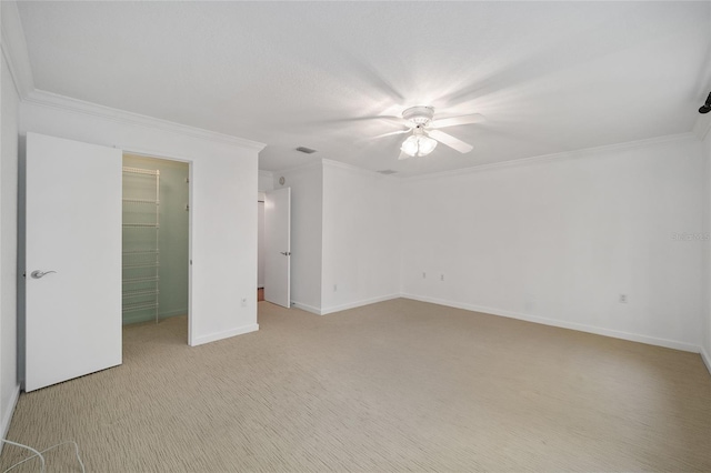 3200 NW 21st Ave, Gainesville, FL 32605 - unfurnished bedroom featuring light colored carpet, crown molding, a spacious closet, baseboards, and ceiling fan