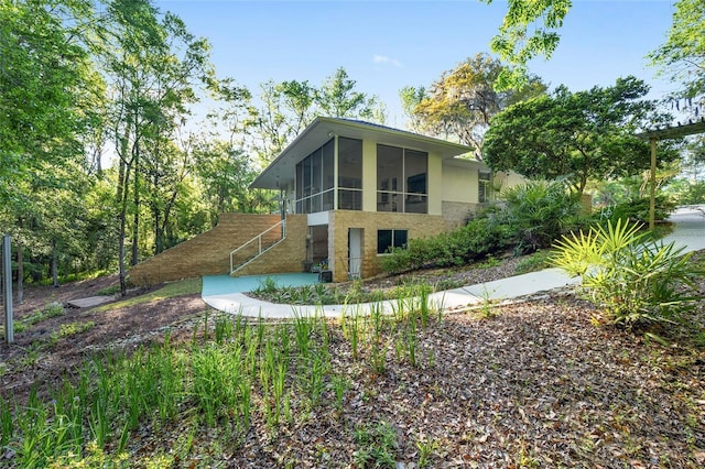 3200 NW 21st Ave, Gainesville, FL 32605 - view of property exterior featuring a sunroom and stucco siding