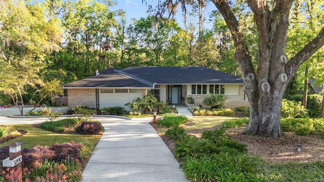 3200 NW 21st Ave, Gainesville, FL 32605 - ranch-style home with an attached garage, concrete driveway, and brick siding