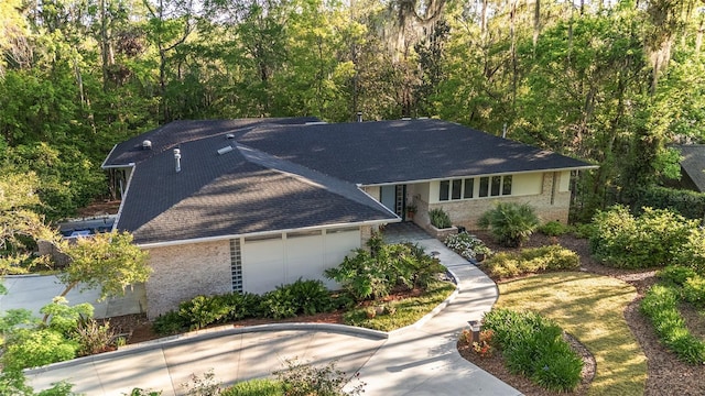 3200 NW 21st Ave, Gainesville, FL 32605 - view of front facade with brick siding, an attached garage, and a shingled roof