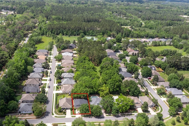 aerial view featuring a wooded view and a residential view