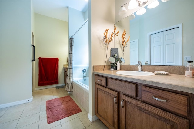 bathroom with curtained shower, vanity, a relaxing tiled tub, and tile patterned flooring