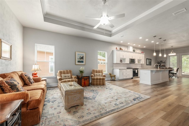 1272 NW 132nd Blvd, Newberry, FL 32669 - living room featuring a tray ceiling, light wood-style floors, ceiling fan, and recessed lighting
