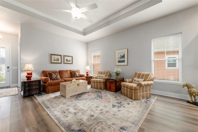 1272 NW 132nd Blvd, Newberry, FL 32669 - living area with a raised ceiling, wood finished floors, ceiling fan, and baseboards