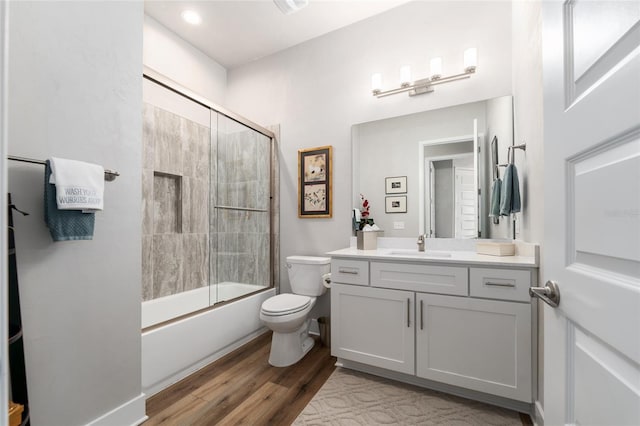 1272 NW 132nd Blvd, Newberry, FL 32669 - full bathroom featuring wood finished floors, toilet, vanity, and combined bath / shower with glass door
