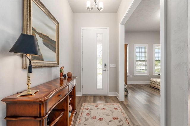 1272 NW 132nd Blvd, Newberry, FL 32669 - foyer with wood finished floors, a chandelier, and baseboards