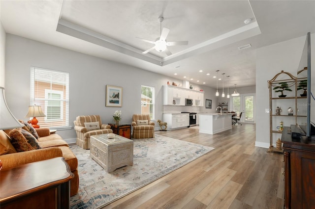 1272 NW 132nd Blvd, Newberry, FL 32669 - living area with a raised ceiling, a ceiling fan, light wood-style flooring, baseboards, and recessed lighting