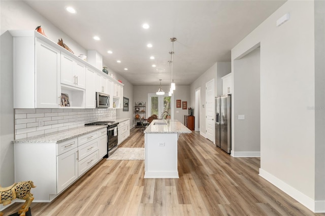 1272 NW 132nd Blvd, Newberry, FL 32669 - kitchen featuring appliances with stainless steel finishes, recessed lighting, a kitchen island with sink, white cabinetry, and tasteful backsplash