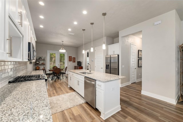 1272 NW 132nd Blvd, Newberry, FL 32669 - kitchen featuring stainless steel appliances, a sink, light wood-style flooring, backsplash, and recessed lighting