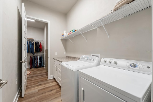 1272 NW 132nd Blvd, Newberry, FL 32669 - laundry area with washer and clothes dryer, light wood-style floors, and cabinet space
