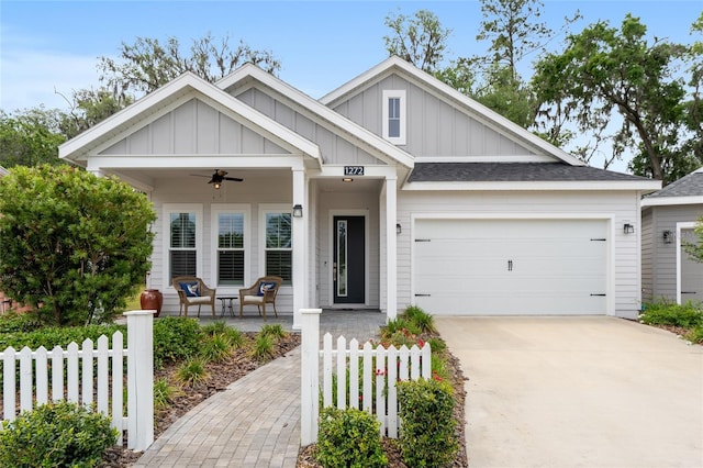 1272 NW 132nd Blvd, Newberry, FL 32669 - view of front of house featuring board and batten siding, fence, driveway, and an attached garage