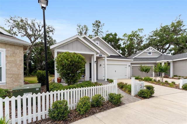 1272 NW 132nd Blvd, Newberry, FL 32669 - view of front facade with board and batten siding, driveway, an attached garage, and a fenced front yard