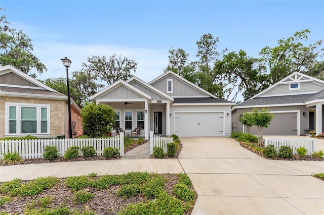 1272 NW 132nd Blvd, Newberry, FL 32669 - craftsman house featuring board and batten siding, a fenced front yard, a porch, and driveway