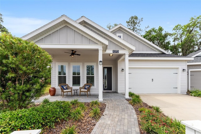 1272 NW 132nd Blvd, Newberry, FL 32669 - view of front of property with board and batten siding, ceiling fan, concrete driveway, and an attached garage