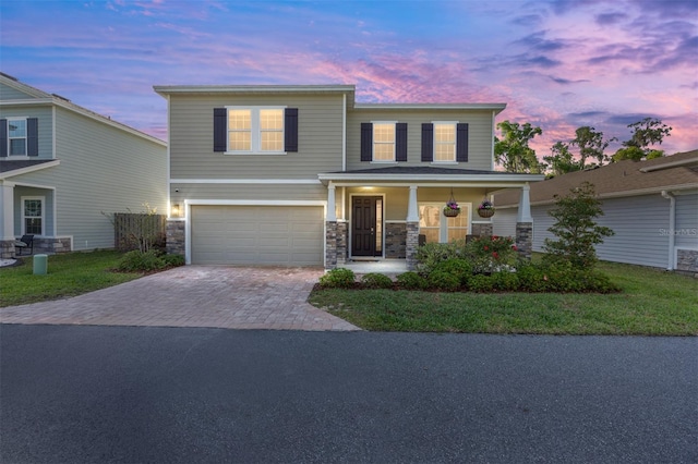 1487 NW 136th Blvd, Newberry, FL 32669 - view of front facade with driveway, covered porch, stone siding, and a garage