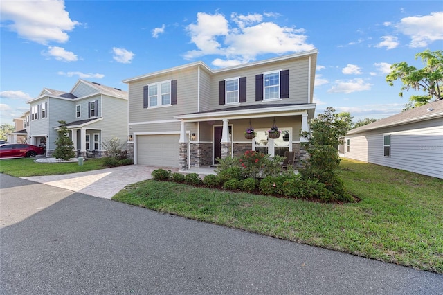 1487 NW 136th Blvd, Newberry, FL 32669 - view of front of house featuring stone siding, decorative driveway, a garage, a front yard, and a porch