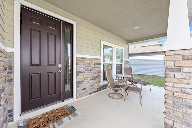 1487 NW 136th Blvd, Newberry, FL 32669 - doorway to property with stone siding and a porch